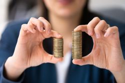 hands holding two stacks of coins