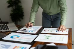 reviewing printed reports with calculator on desk