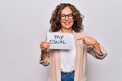 woman holding pay equal sign