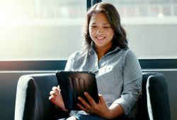 woman on tablet smiling